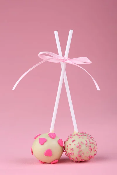 Cake pops on pink background. Closeup