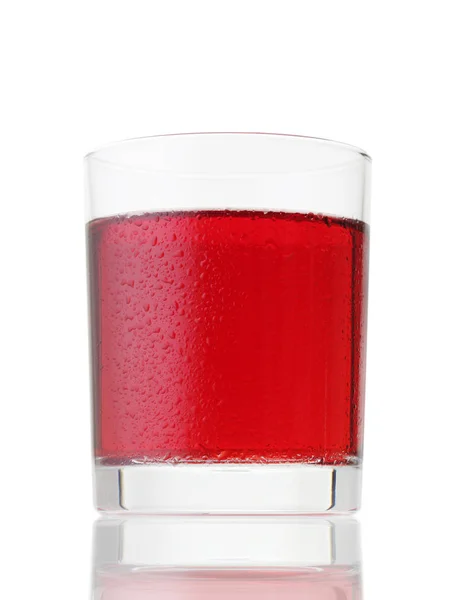 Glas rotes Getränk mit Wassertropfen auf weißem — Stockfoto