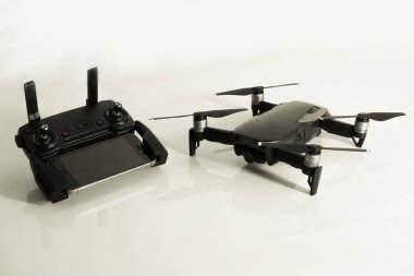 DJI Mavic Air drone with controller and smartphone on white background clipart