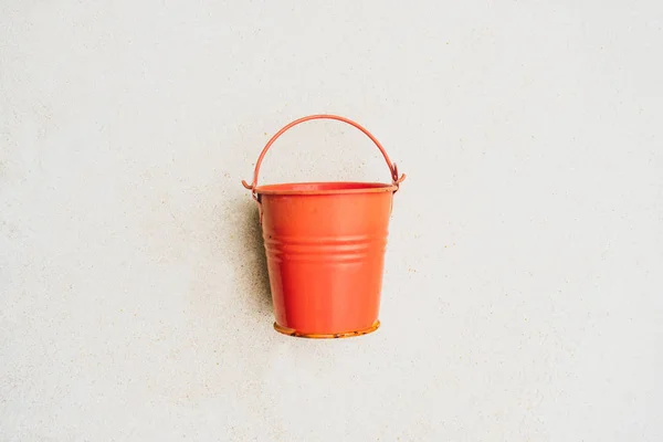 Coral watering bucket for plants on white background