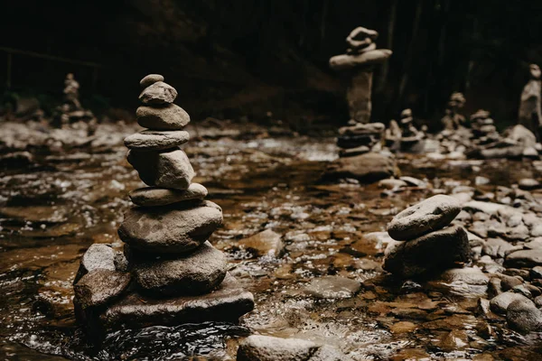 stone tower pyramids on a mountain river