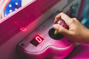 Seçici odak arcade oyunu oynarken oğlanın elini yukarıya kapatmak.