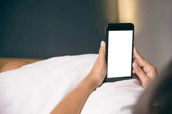 Asyalı kadının el sabah yatak boş ekran smartphone kullanarak.