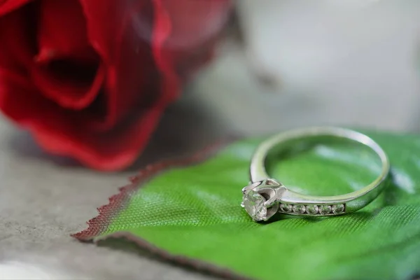 Diamond ring on the leaf of beautiful blossoming rose