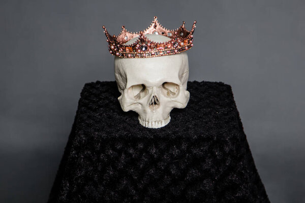 A human skull with a crown lies on the altar.
