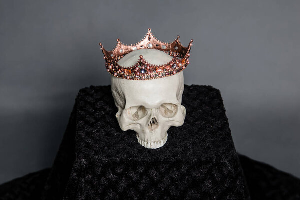 A human skull with a crown lies on the altar.