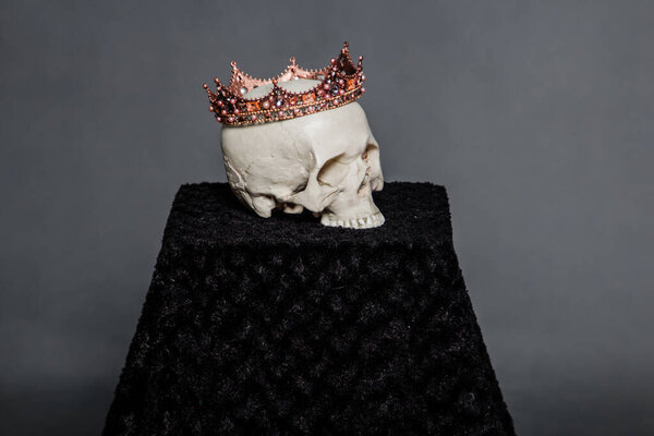 A human skull with a crown lies on the altar.