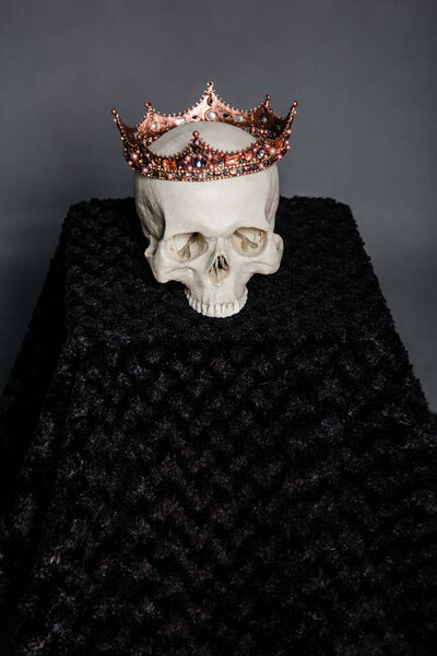 A human skull with a crown lies on the altar.