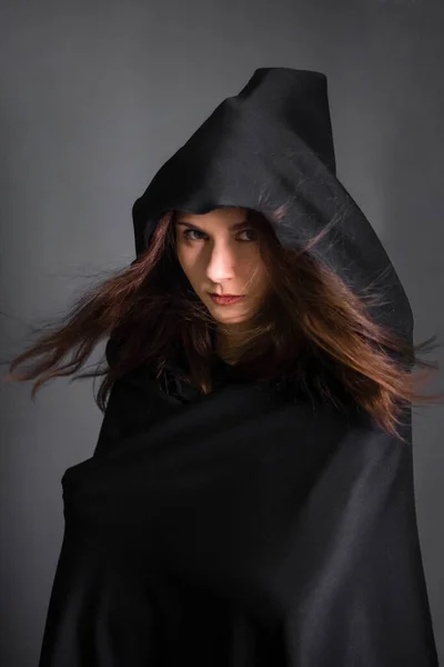 Young Beautiful Woman Black Cloak Hood Studio Gray Background Long — Stock Photo, Image