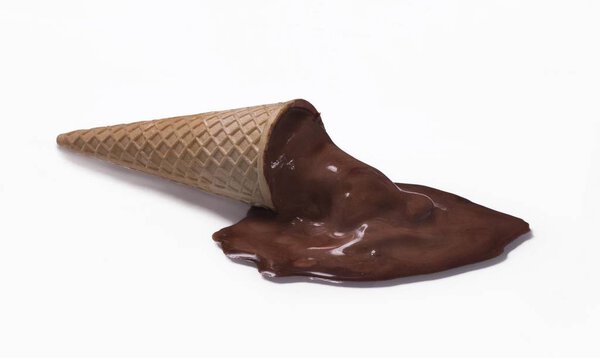 Melted chocolate ice cream cone fallen on white background.