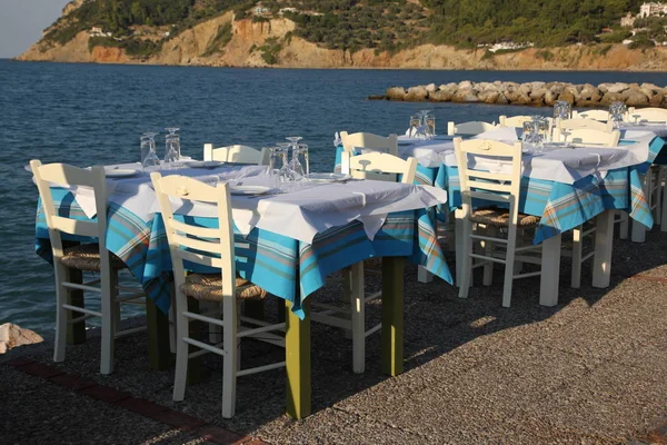 Restaurant in the open air by the sea, evening. Mediterranean Sea, South of Europe, Greece, Skopelos Island.