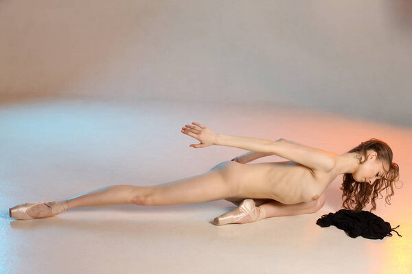 Stylish portrait of young woman. Beauty naked woman posing on light studio background