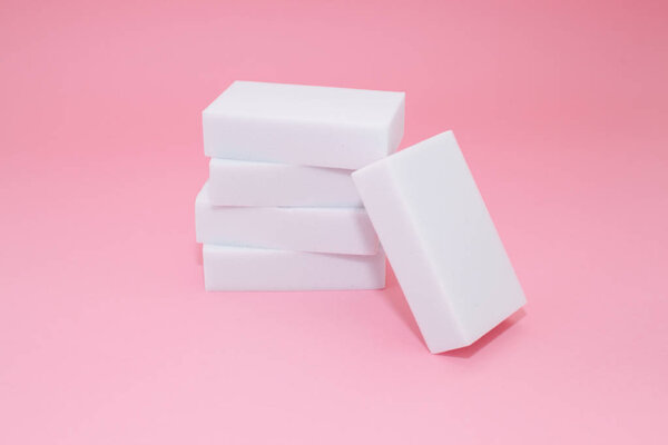 Melamine sponge stack on pink background