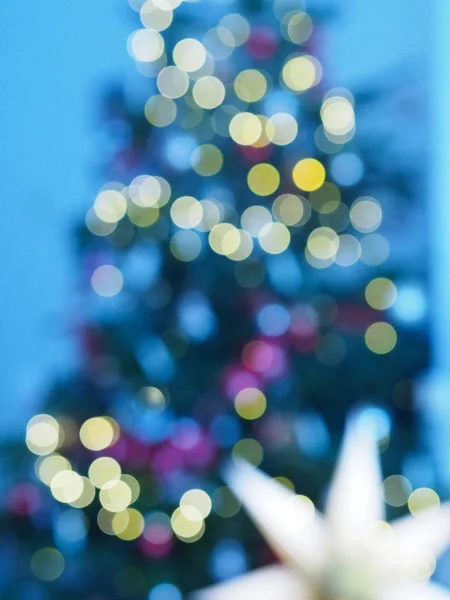 Christmas tree with defocused lights and star.