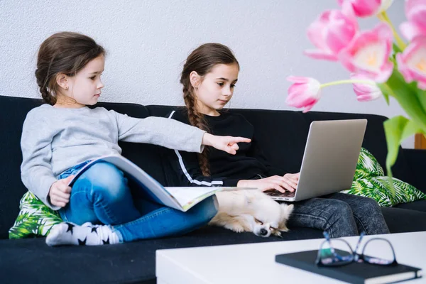 Online education, distance learning, homeschooling. Children studying homework during online lesson at home in tablet of laptop and holding videocall. Social distance on quarantine. Self-isolation