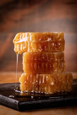 Honey background. Sweet honey in the comb. On wooden background.	