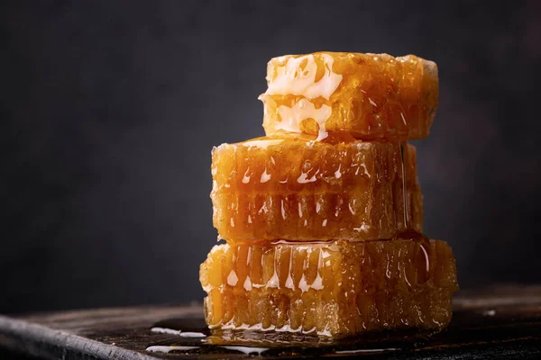 Honey background. Sweet honey in the comb. On wooden background.	