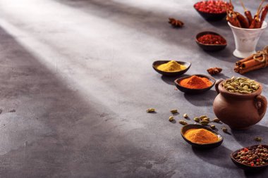 Wooden table of colorful spices, copy space for your content.	