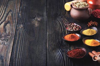Wooden table of colorful spices, copy space for your content.	