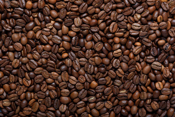 Roasted brown coffee beans, can be used as a background and texture. Top view
