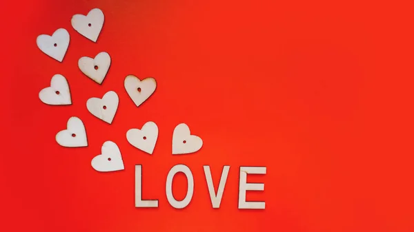Valentines Day background with red hearts and letters love - made of wood on red — Stock Photo, Image