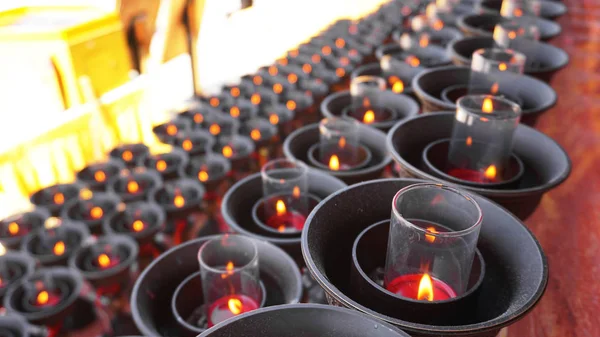 Burning big red candles in Buddhist temple — Stock Photo, Image