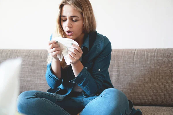 Portrait of unhealthy cute blonde female with napkin blowing nose. Cold, allergy — Stock Photo, Image