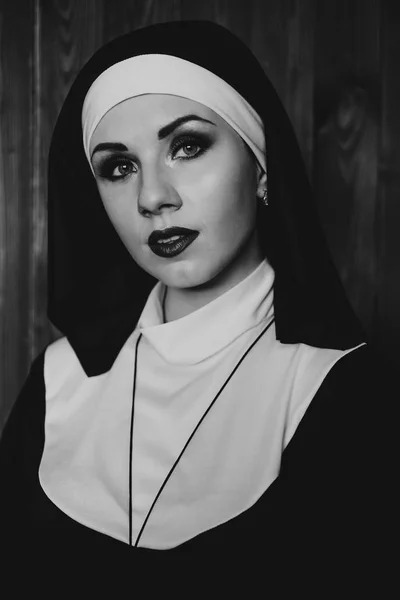Sexy nun prays indoor. Beautiful young holy sister.