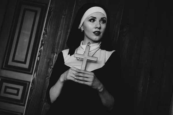 Sexy nun prays indoor. Beautiful young holy sister.