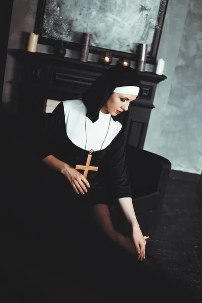 Sexy nun prays indoor. Beautiful young holy sister.