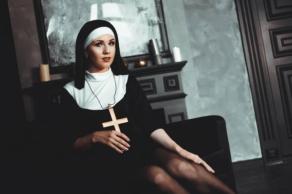 Sexy nun prays indoor. Beautiful young holy sister.