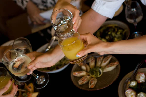 Group of friends enjoying appetizer in bar — Stock Photo, Image