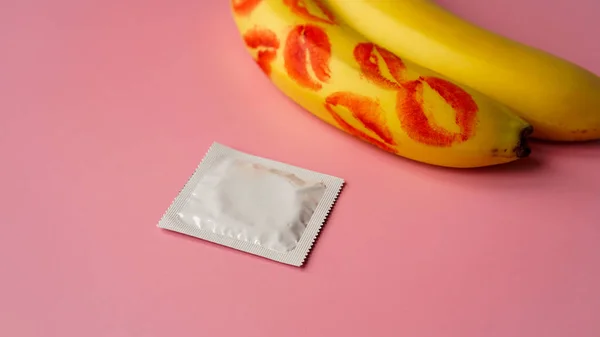 Condoms and two bananas with traces of red lipstick, concept of contraceptives