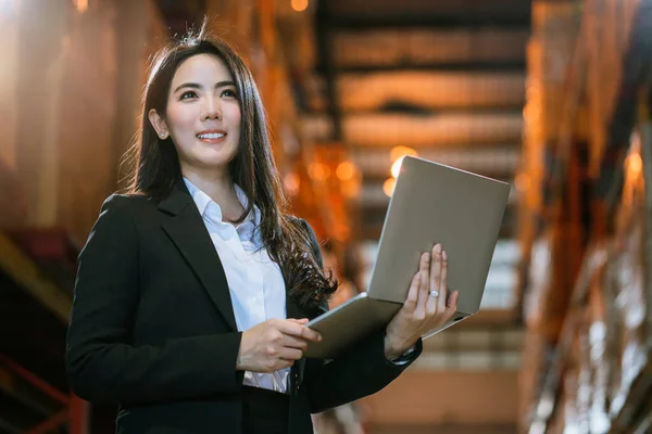 Asyalı kadın iş adamının portresi resmi takım elbise ürün envanterini kontrol et kendine güvenen depo fabrikası geçmişi olan iş yatırımcısı anlaşması ve takım çalışması konsepti.