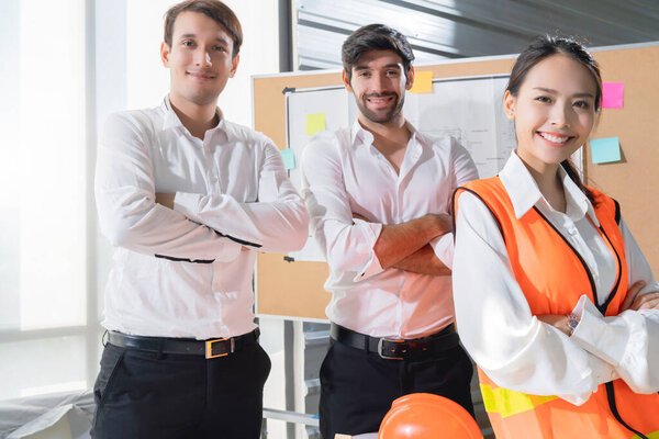 Portrait of smart attractive asian and cuacasian male and female coworkers engineer teamwork formal cloths in meeting room smile with cheerful and confident white office big window daylight background