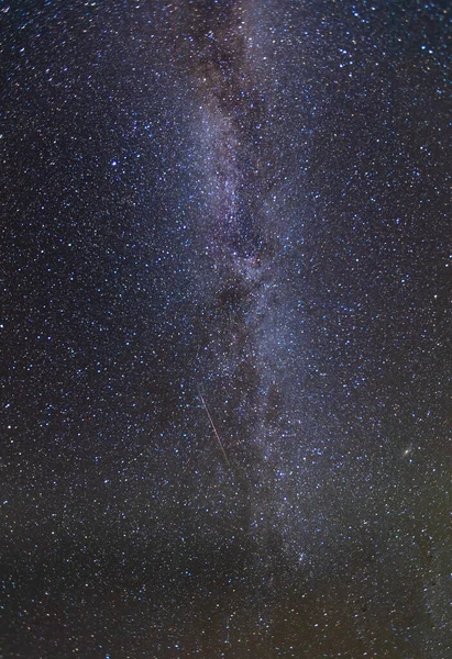 Shooting star goes across the milky way in the Unitas national forest in Utah