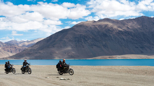 Ladakh, India - Rider at Pangong Lake view from Between Merak and Maan in Ladakh, Jammu and Kashmir, India.