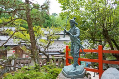 Kyoto, Japan - Miyamoto Musashi Statue at Hachidai-Jinja Shrine in Kyoto, Japan. Miyamoto Musashi (1584-1645) was a Japanese swordsman, philosopher, strategist, writer and ronin. clipart