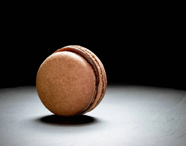 Schokoladenmacaron auf schwarzem Hintergrund — Stockfoto