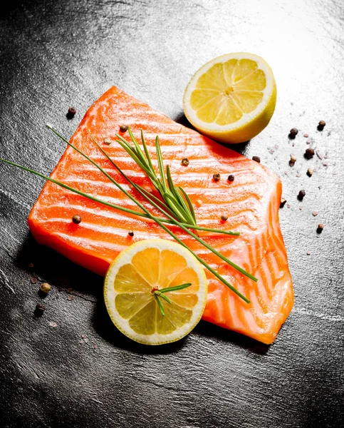 Juicy salmon fillet on black slate plate — Stock Photo, Image
