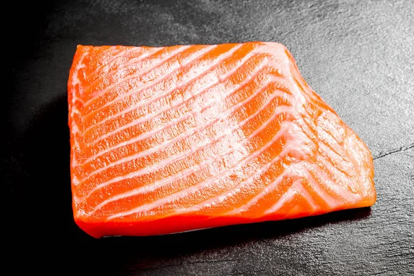 Beautiful salmon fillet on slate plate — Stock Photo, Image