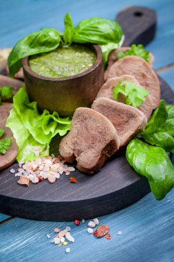 Pesto ve salata ile koyu ahşap tabloda haşlanmış Dana dil