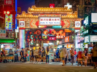 Taipei, Taiwan - Aug 1, 2018: Tourists are shopping around the famous Raohe Street Night Market.  clipart