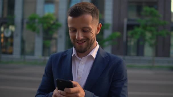 Kaukasier benutzt Handy in der Stadt — Stockvideo