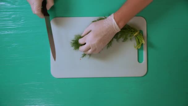 Koch schneidet Dill auf weißem Brett — Stockvideo