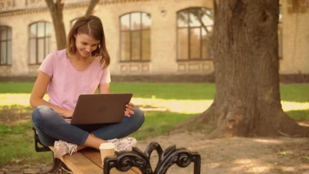 Young woman use computer at the open air — Stock Video