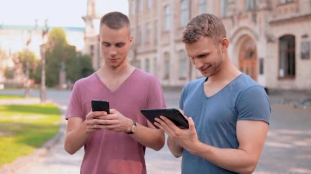 Portret vrienden met apparaten op het gebied van de campus — Stockvideo