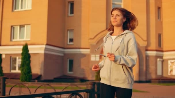 Caucasian girl jogging at sunset — Stock Video