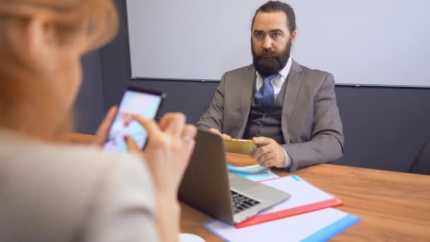 Kollegen aus der Wirtschaft arbeiten zusammen. Frau wendete sich mit Blick auf Smartphone ab — Stockvideo