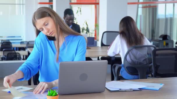 Multitasking Manager Praktikant mit blonden Haaren am Arbeitsplatz — Stockvideo